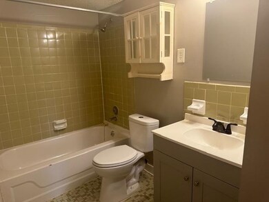 Full bathroom featuring tile patterned flooring, t