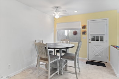 Dining space with light tile patterned floors, ceiling fan, and recessed lighting