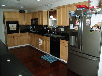 Up-To-Date Kitchen with hard wood floors, stainles