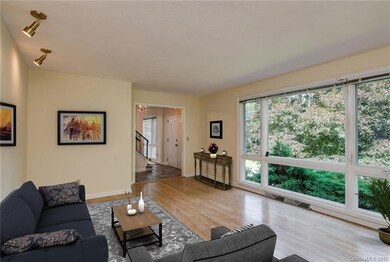 Living room with tree top view and solid hardwood 
