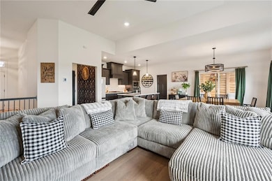 Living area with recessed lighting, engineered hardwood floors, and ceiling fan