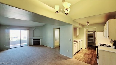 Kitchen featuring light countertops, a fireplace,