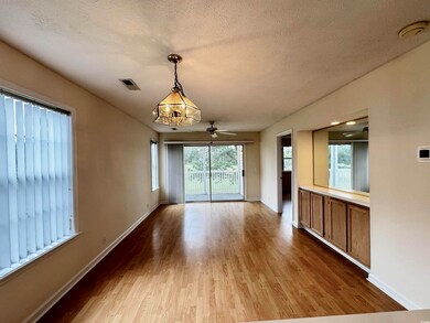 Spare room with wood finished floors, baseboards, a smoke detector, and a textured ceiling