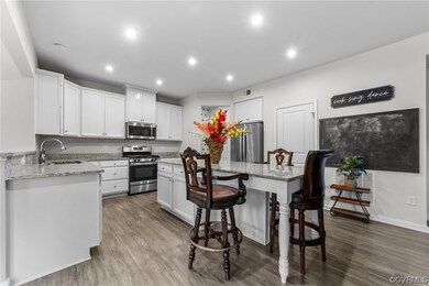Kitchen with white cabinets, stainless steel appli