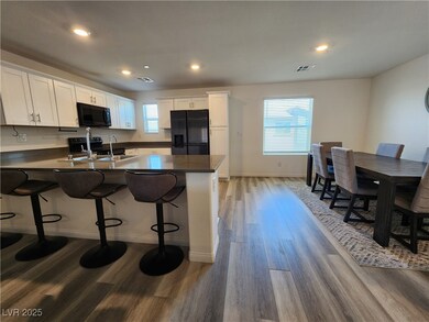 Kitchen featuring black appliances, a peninsula, l
