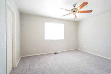 Unfurnished bedroom featuring carpet floors and a ceiling fan