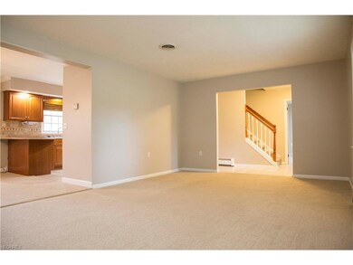 Living room looking into the foyer and kitchen.