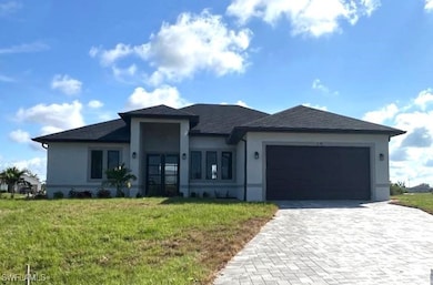 View of front facade with decorative driveway, stu
