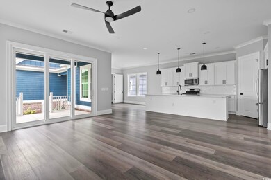 Unfurnished living room featuring ceiling fan, dar