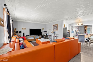 Living room featuring a chandelier, light wood-sty