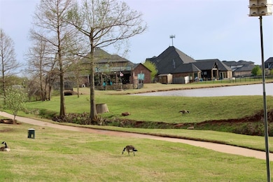 View of property's community featuring  a yard and