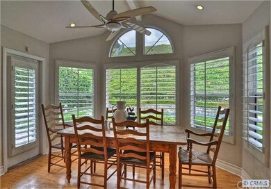 charming kitchen  nook  enjoys a pool view.