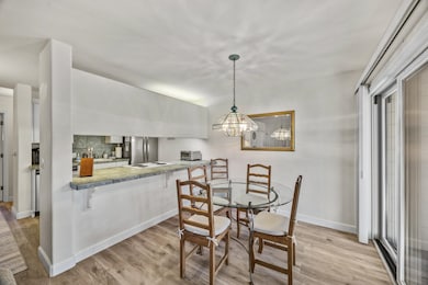 The dining area is open to the living area and provides access to your deck with Lake views.