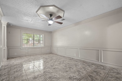 Spacious room with neutral walls and decorative mo