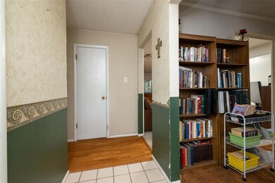 Home office with crown molding and light hardwood 