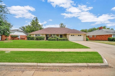 Ranch-style house with a front lawn and a garage