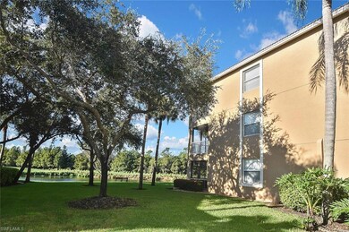 View of grassy yard with a water view and a balcony
