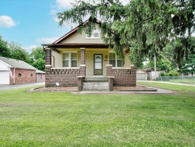 Fantastic bungalow on over half an acre zoned light commercial with a beautiful front porch and 4 season-room with a working hot tub!