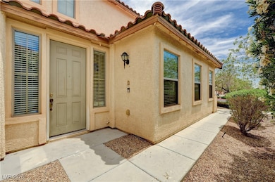 Entrance to property with stucco siding and a tile
