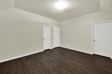 This is a spacious, well-lit room with neutral wal