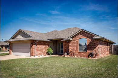 Ranch-style house with a garage and a front lawn