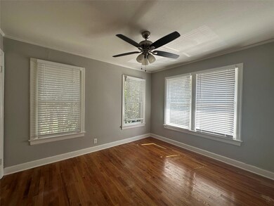 Unfurnished room featuring wood finished floors, b