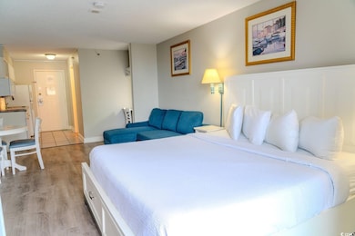 Bedroom with light wood finished floors and baseboards