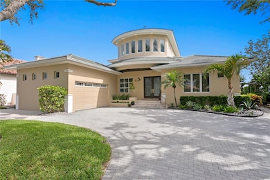 Front Elevation with one of a kind Tom Pici designed entrance: Tourette rising above the Brazilian Wood Doors.