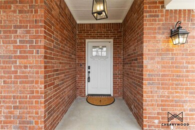 Doorway to property featuring brick siding