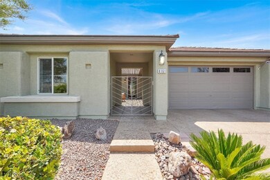 View of front facade with stucco siding, a garage,