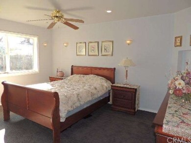 Bedroom with recesssed lighting and wall sconces