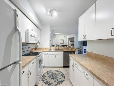 Kitchen featuring sink, white appliances, white ca