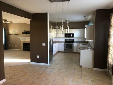 Open concept view from the large foyer, through the dining room, into the large kitchen.