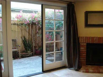 Living room with fireplace opens up onto your priv