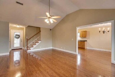 Large family room with vaulted ceilings and hardwood