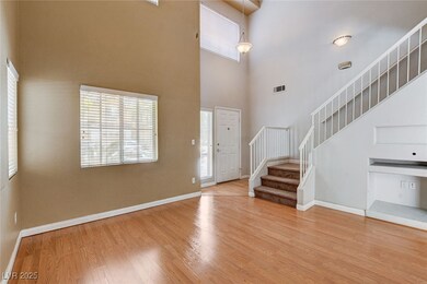 Entrance foyer with a towering ceiling, stairs, wo