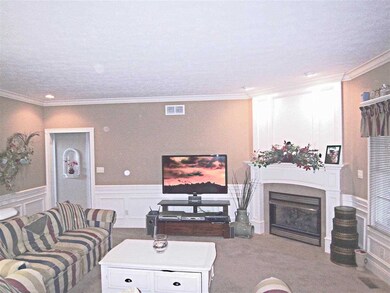 The spacious great room with extensive woodwork, g
