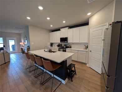 Kitchen featuring appliances with stainless steel