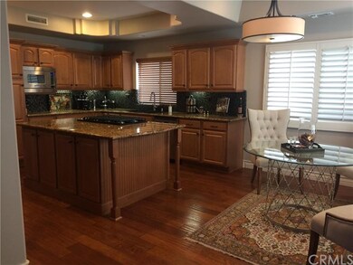 VIEW TO KITCHEN FROM FAMILY AREA WITH ISLAND AND A