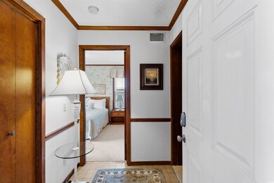 Hall featuring light tile patterned flooring, a te