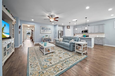 Living room featuring baseboards, dark wood-style 