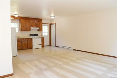 View of open living room and kitchen as seen from the front door.