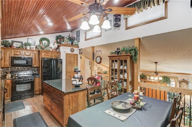 Dining space featuring wood tiled floor, ceiling f