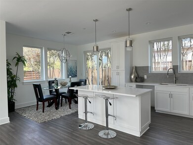 Kitchen with dark wood-type flooring, light count