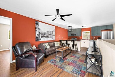 Living room featuring ceiling fan, dark wood-type 