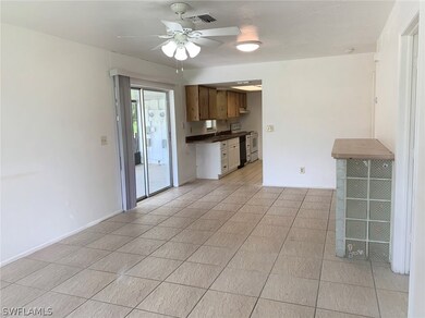 Tiled living room with sliding glass door leading to porch