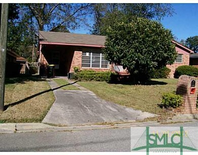 Exterior Front. Paved driveway with custom built b