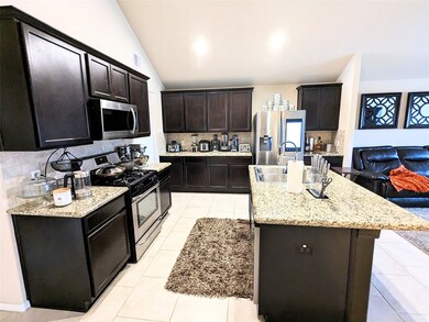 An open concept kitchen with granite countertop