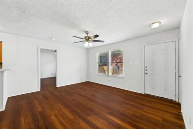 Unfurnished living room featuring ceiling fan, da