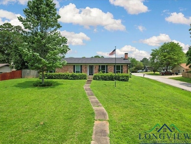 Ranch-style house with brick siding and a chimney